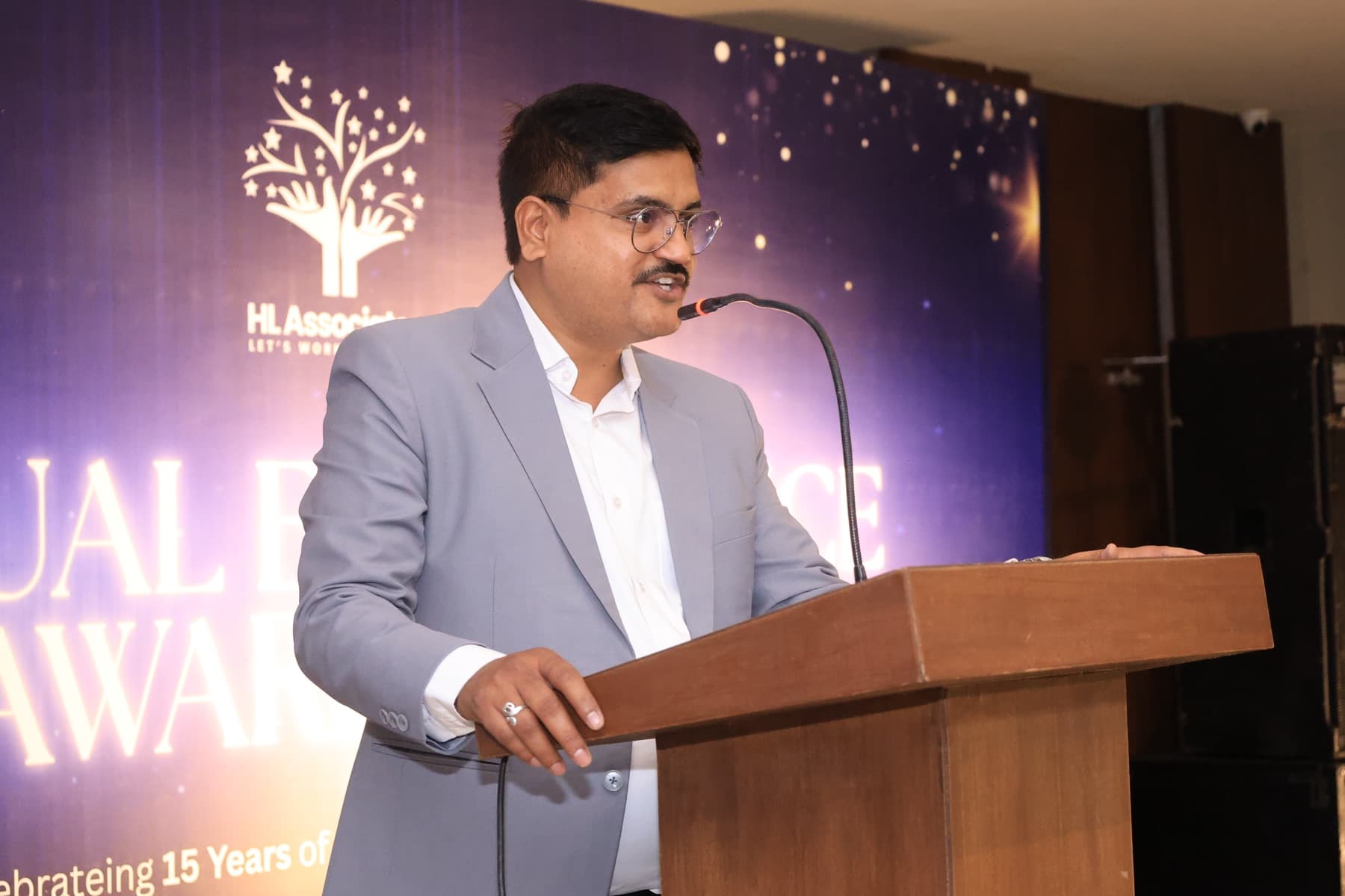 A speaker at the podium during the team trip awards
