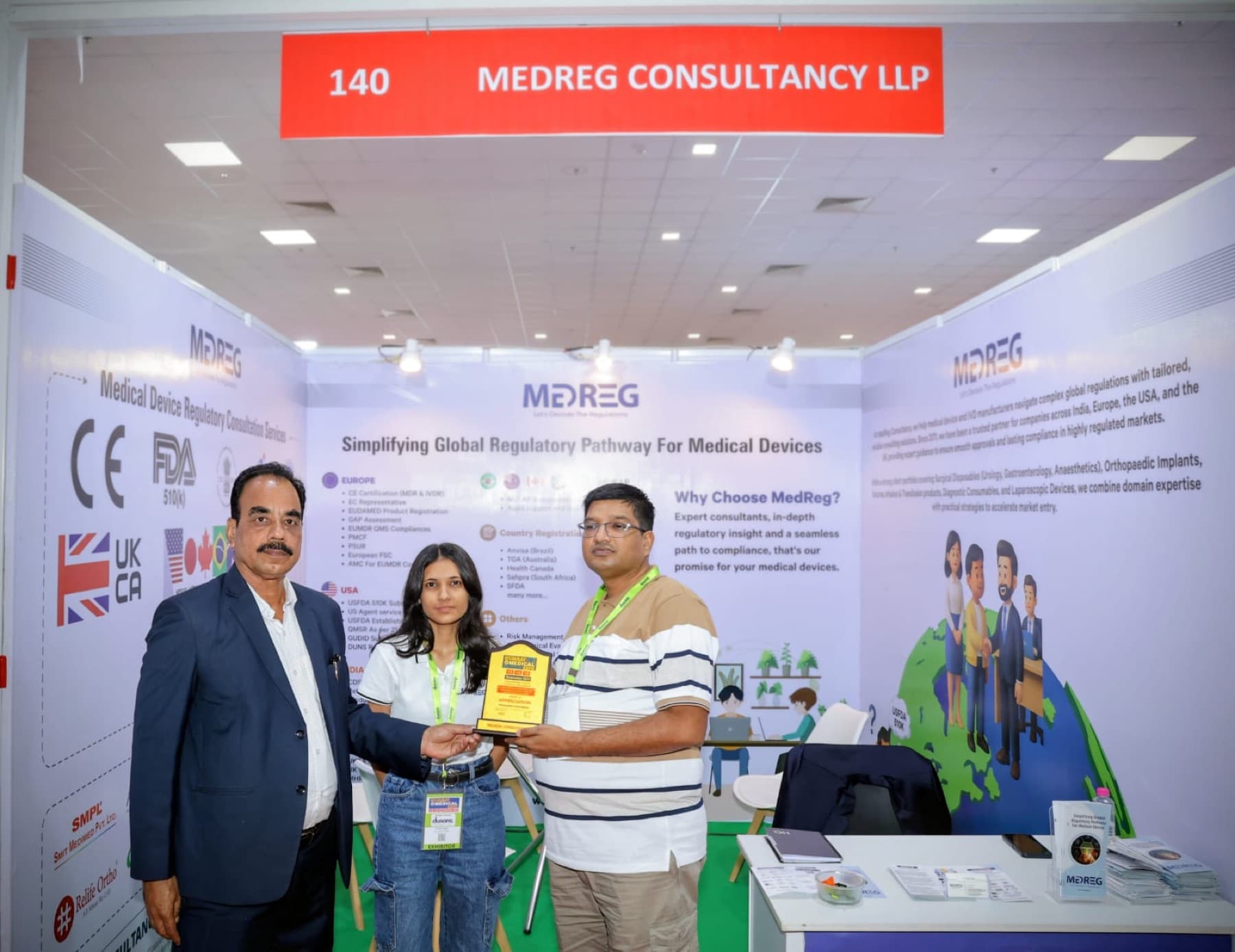 A memento being presented at the MedReg Consultancy LLP exhibition stall