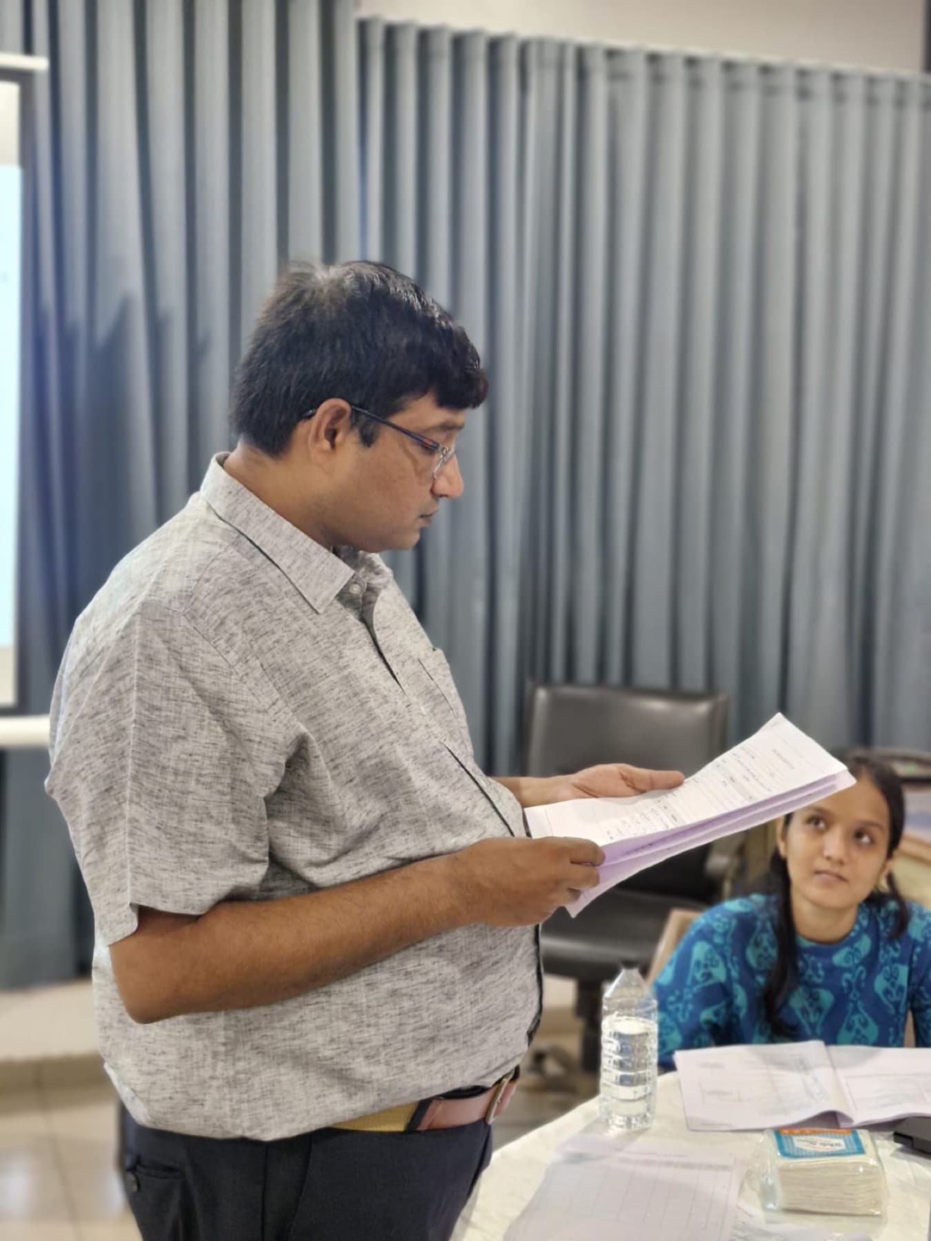 A trainer reading from a document during a training session