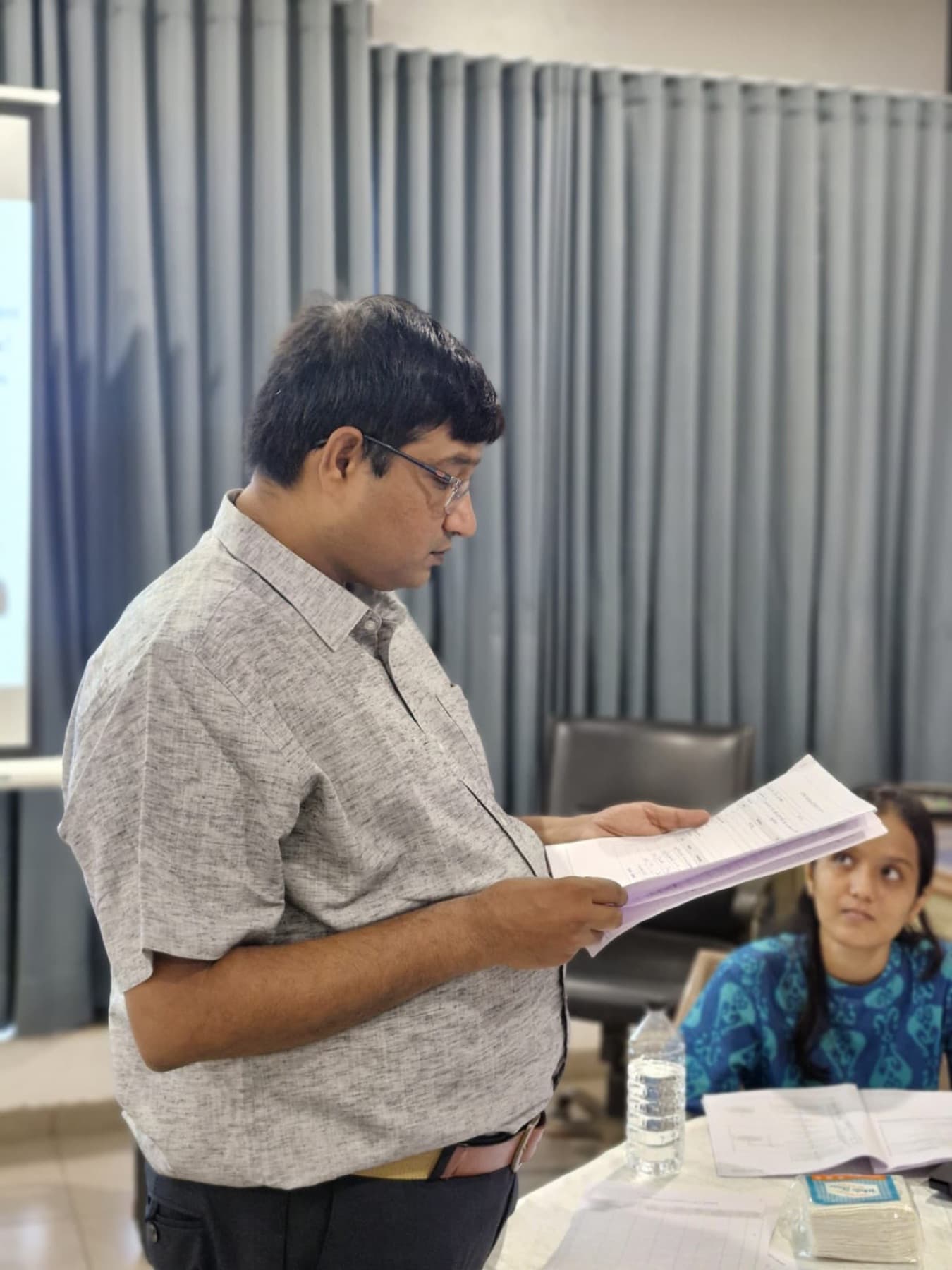 A trainer reviewing a document during a training session