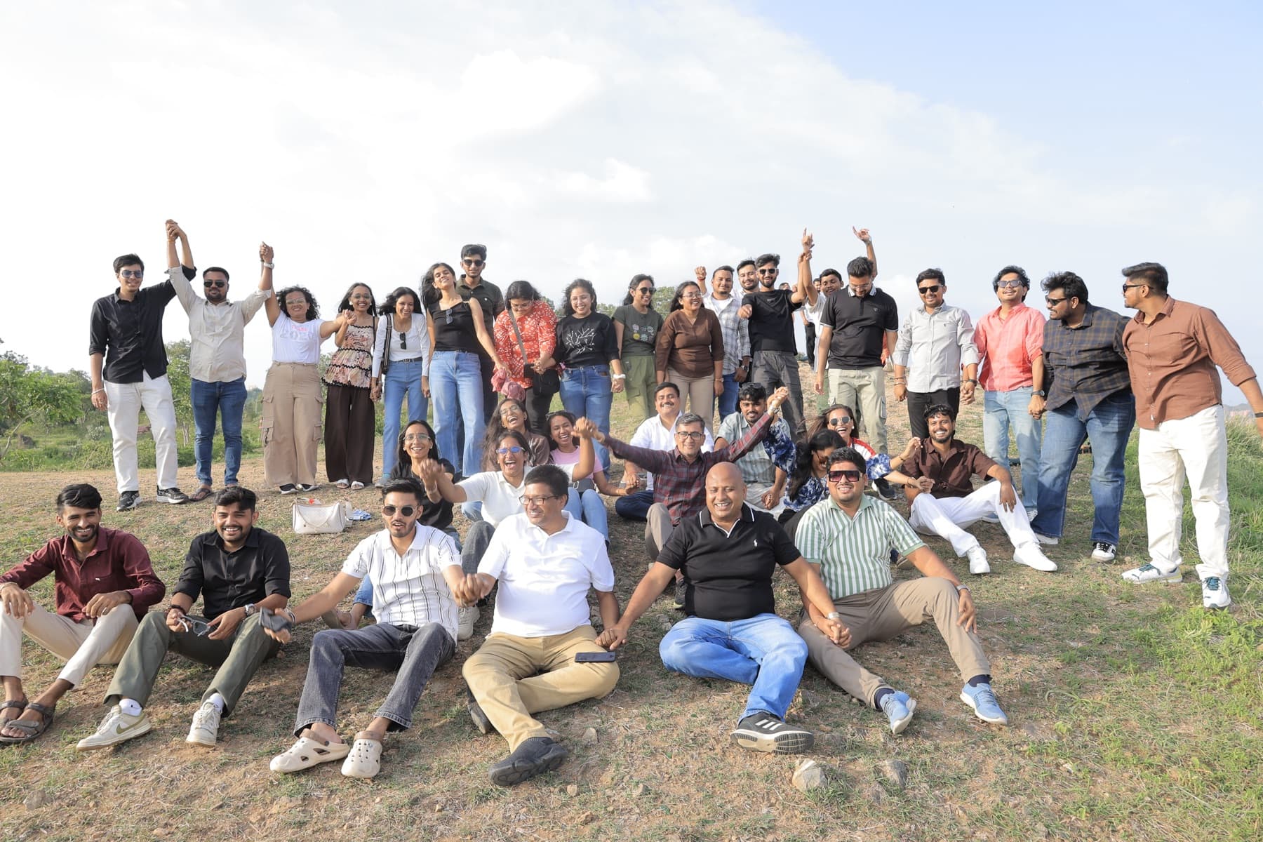The MedReg team cheering on a hilltop during a team trip