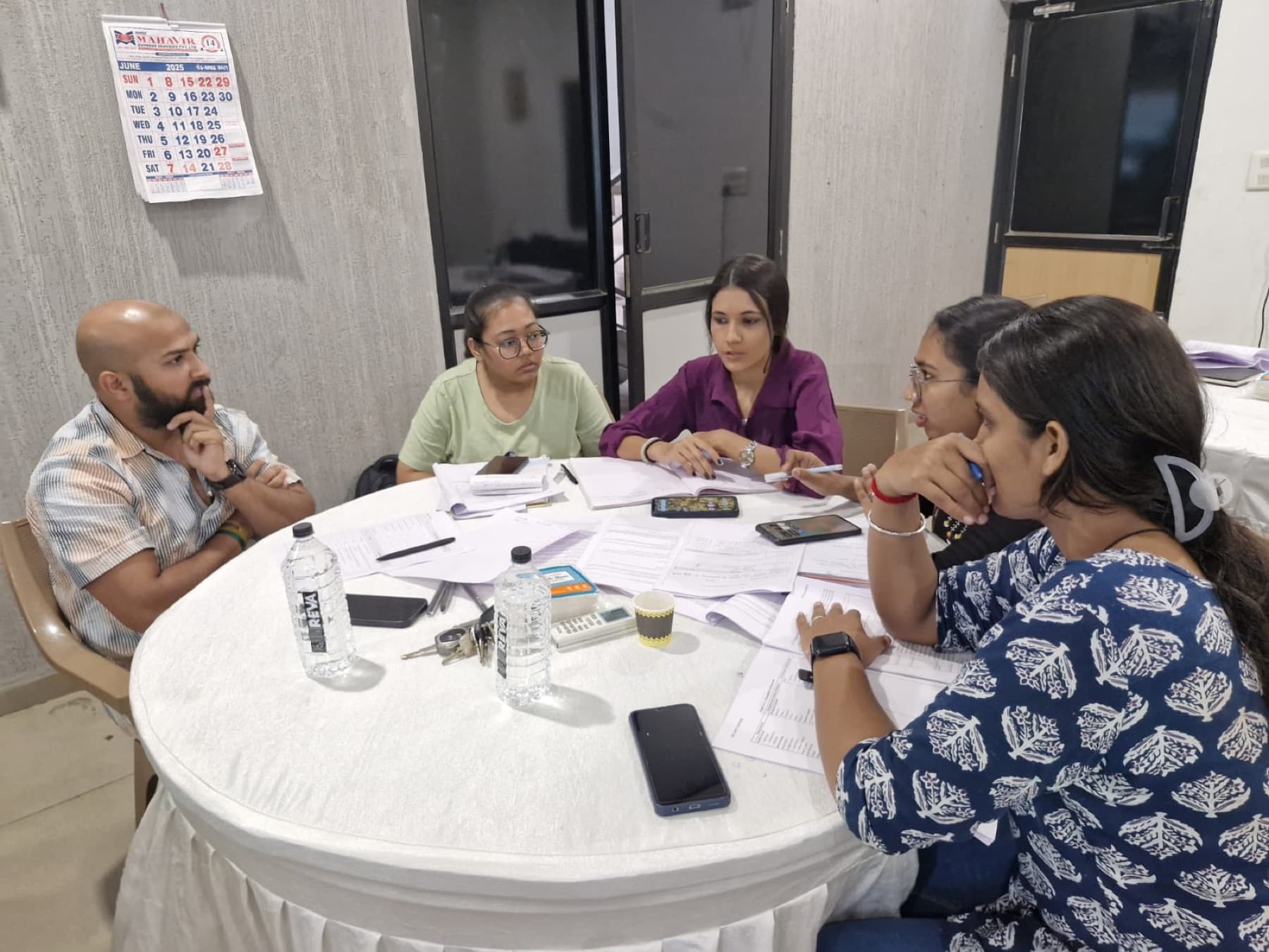 MedReg team members discussing a project around a table