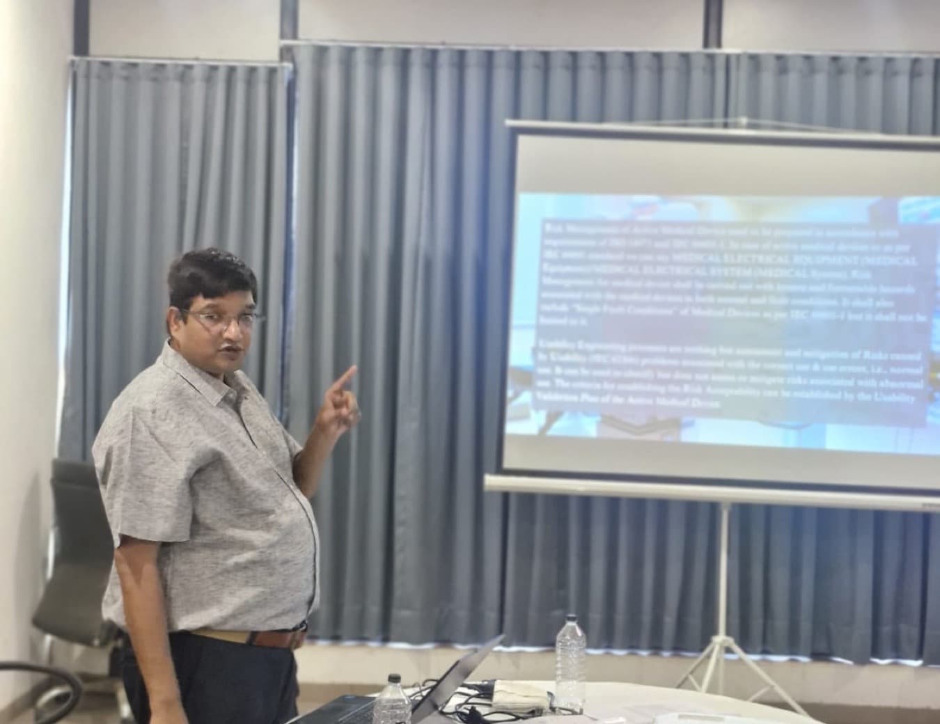 A MedReg trainer presenting slides at a training session